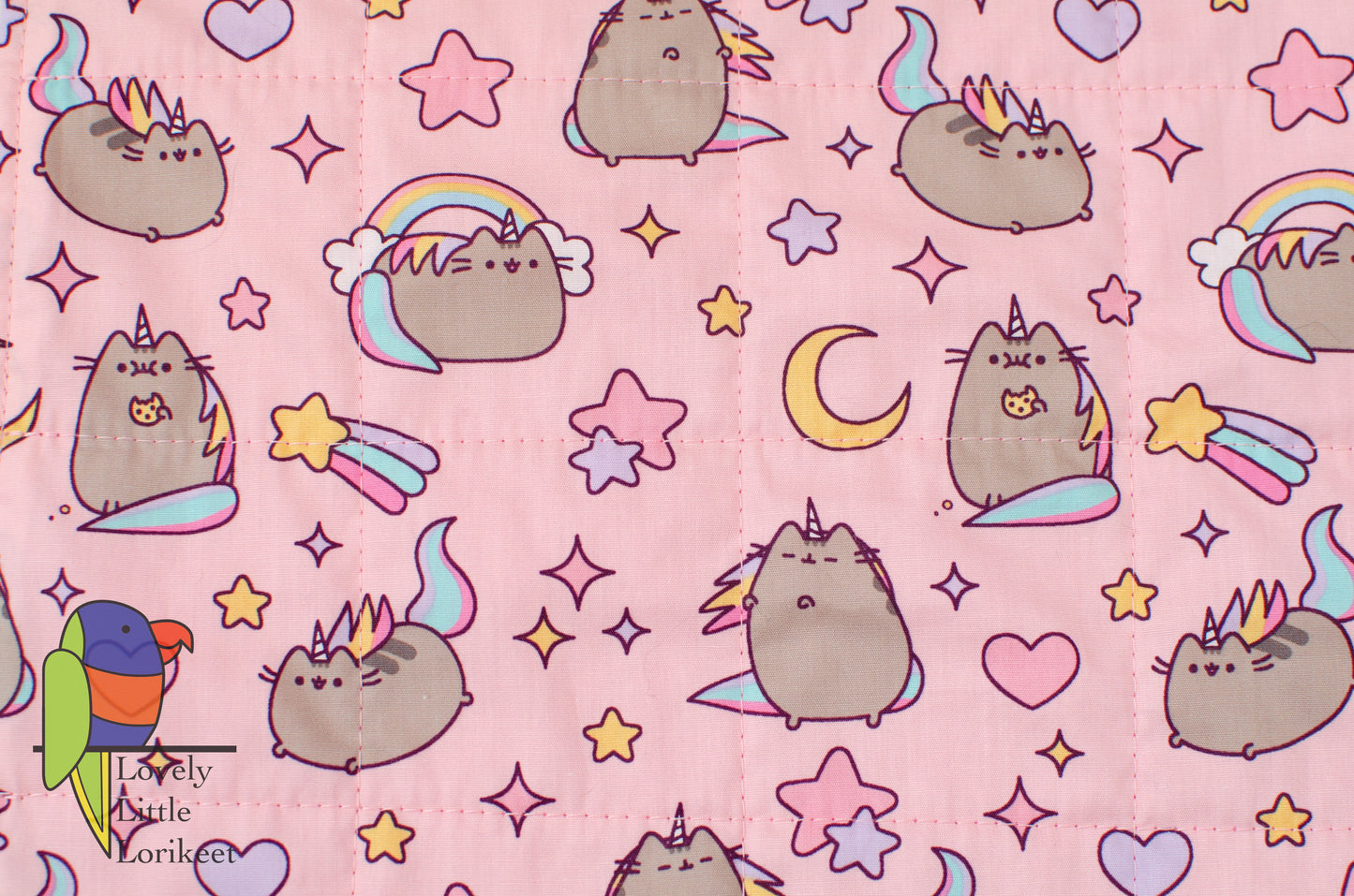 close up photo of the actual fabric with pink background and pusheen detail