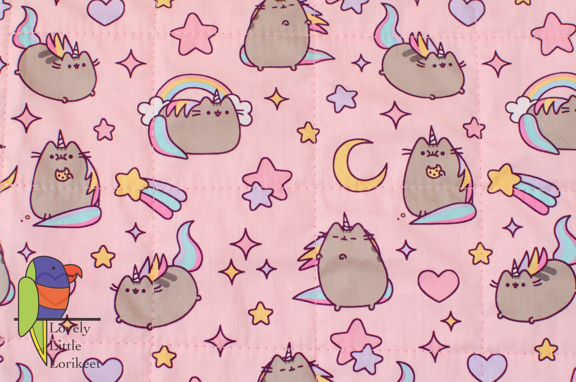 close up photo of the actual fabric with pink background and pusheen detail