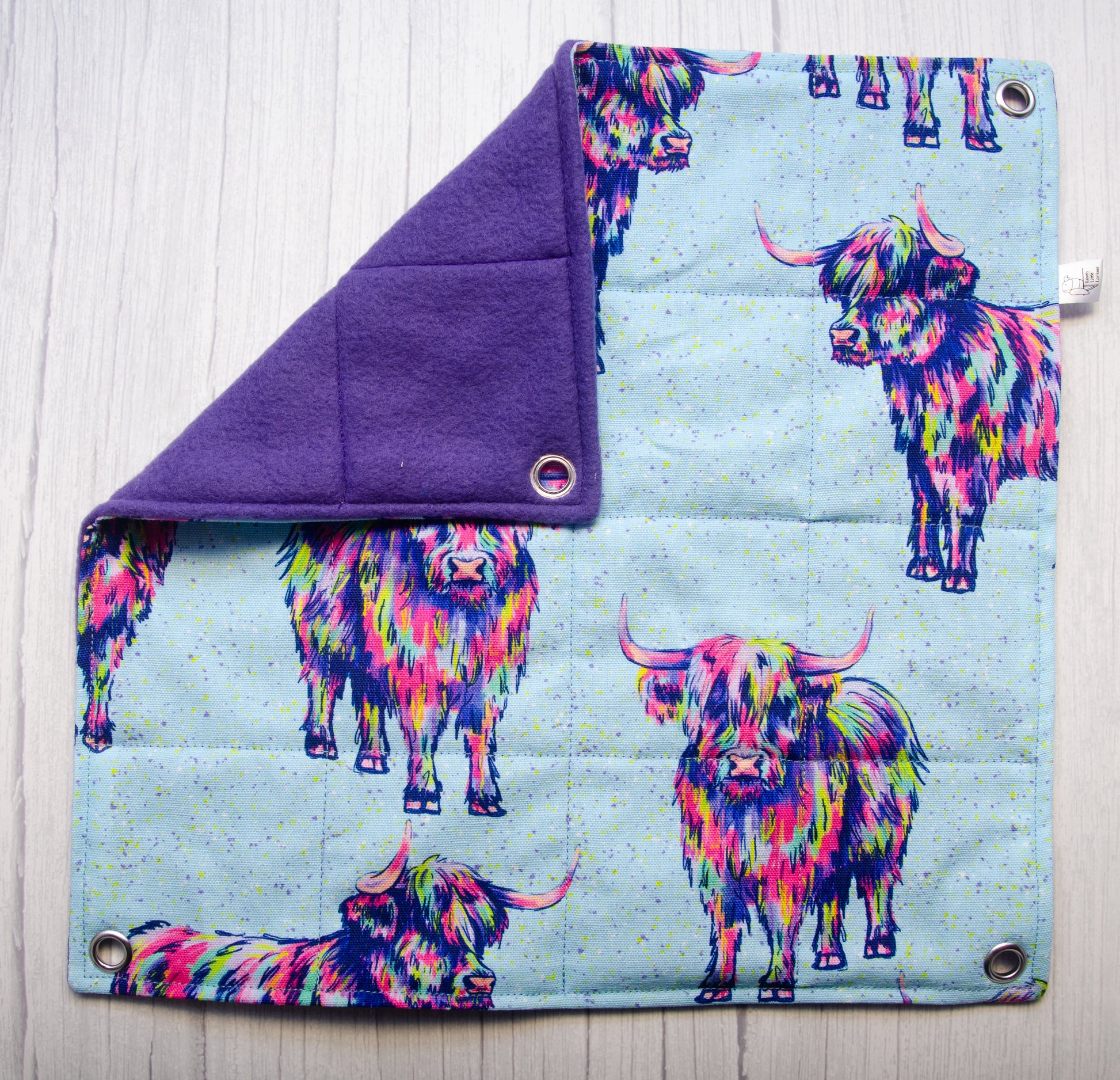 Trippy cows fabric in a flat hammock style with purple fleece