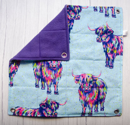 Trippy cows fabric in a flat hammock style with purple fleece