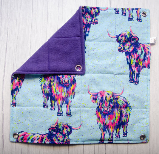 Trippy cows fabric in a flat hammock style with purple fleece