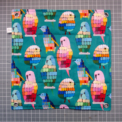 Flat hammock, flat lay, colourful birds in a mosaic pattern, grommets in corners.