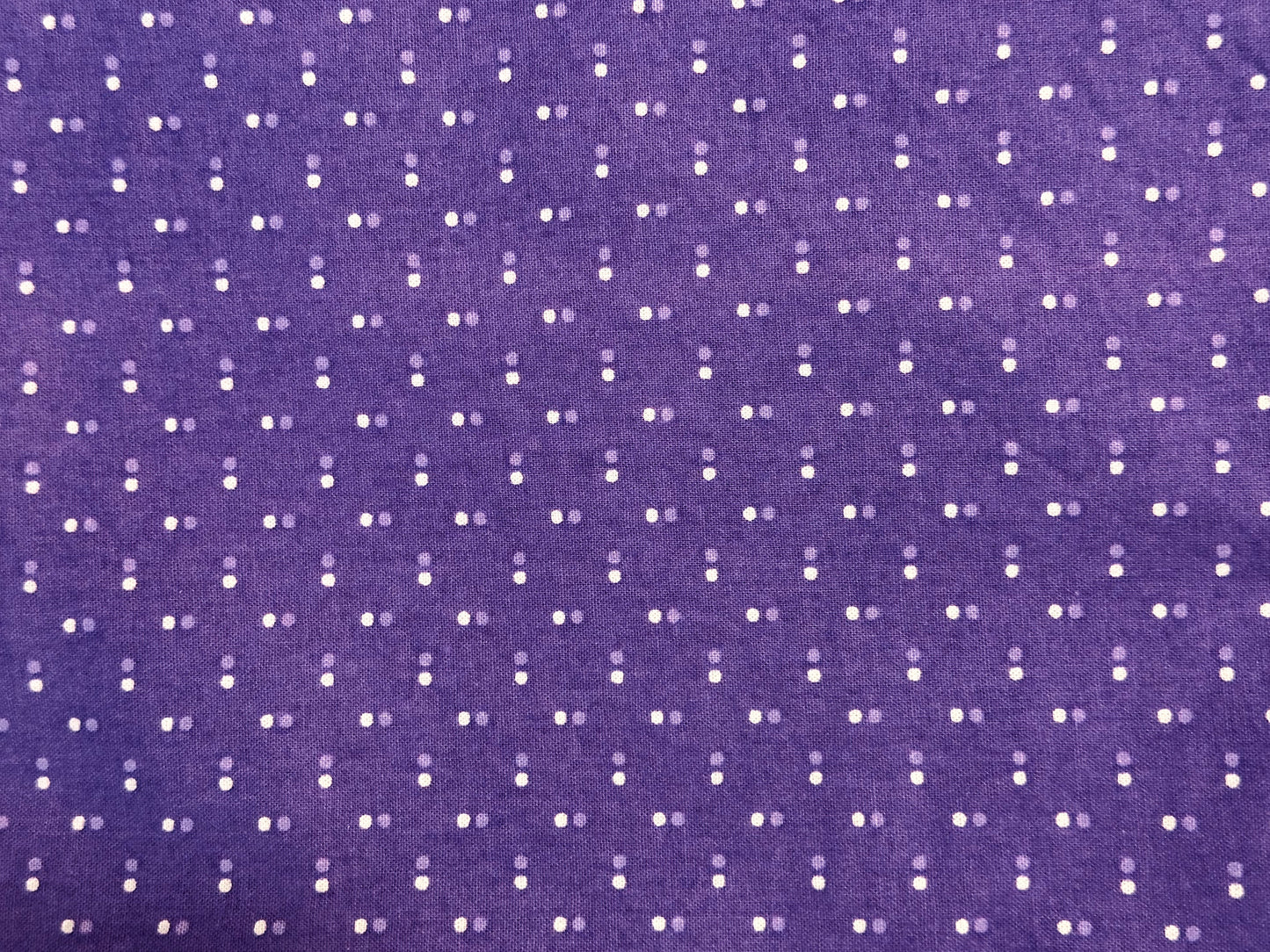 Purple fabric with white polka dot pattern