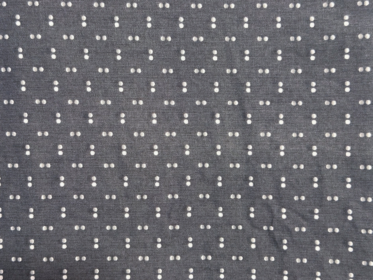 Gray fabric with a small white dot pattern