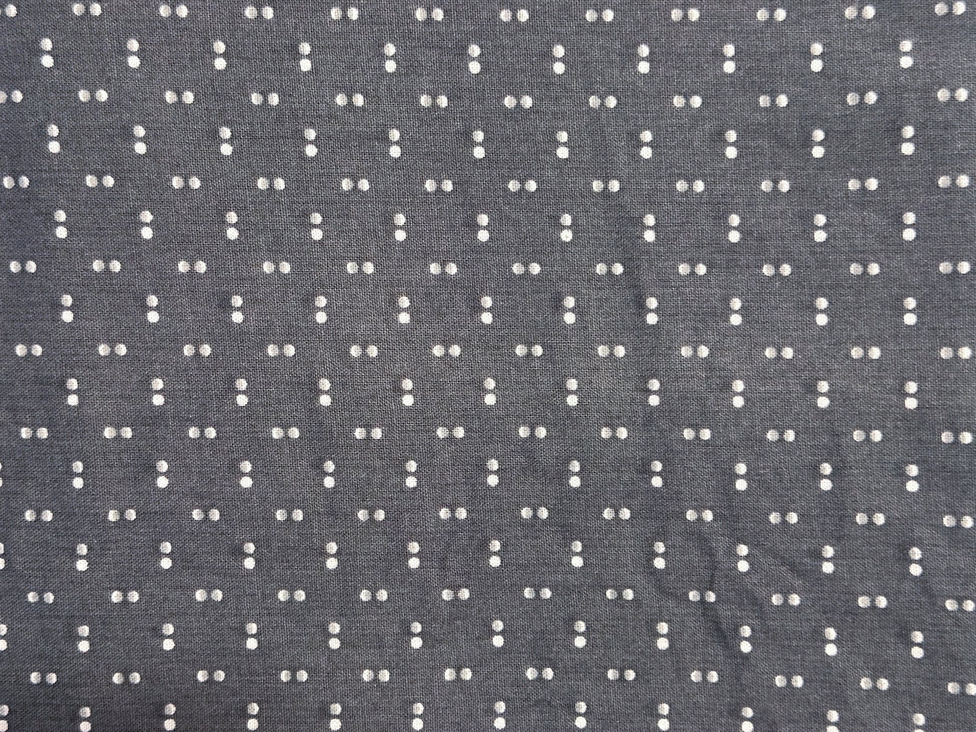 Gray fabric with a small white dot pattern
