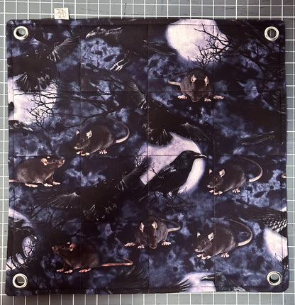 Flat lay flat style hammock with metal grommets in each corner with pictures of rats, crows, trees and the moon.