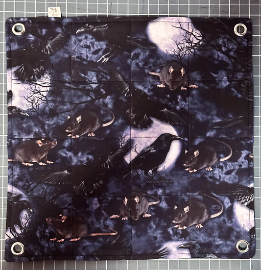 Flat lay flat style hammock with metal grommets in each corner with pictures of rats, crows, trees and the moon.