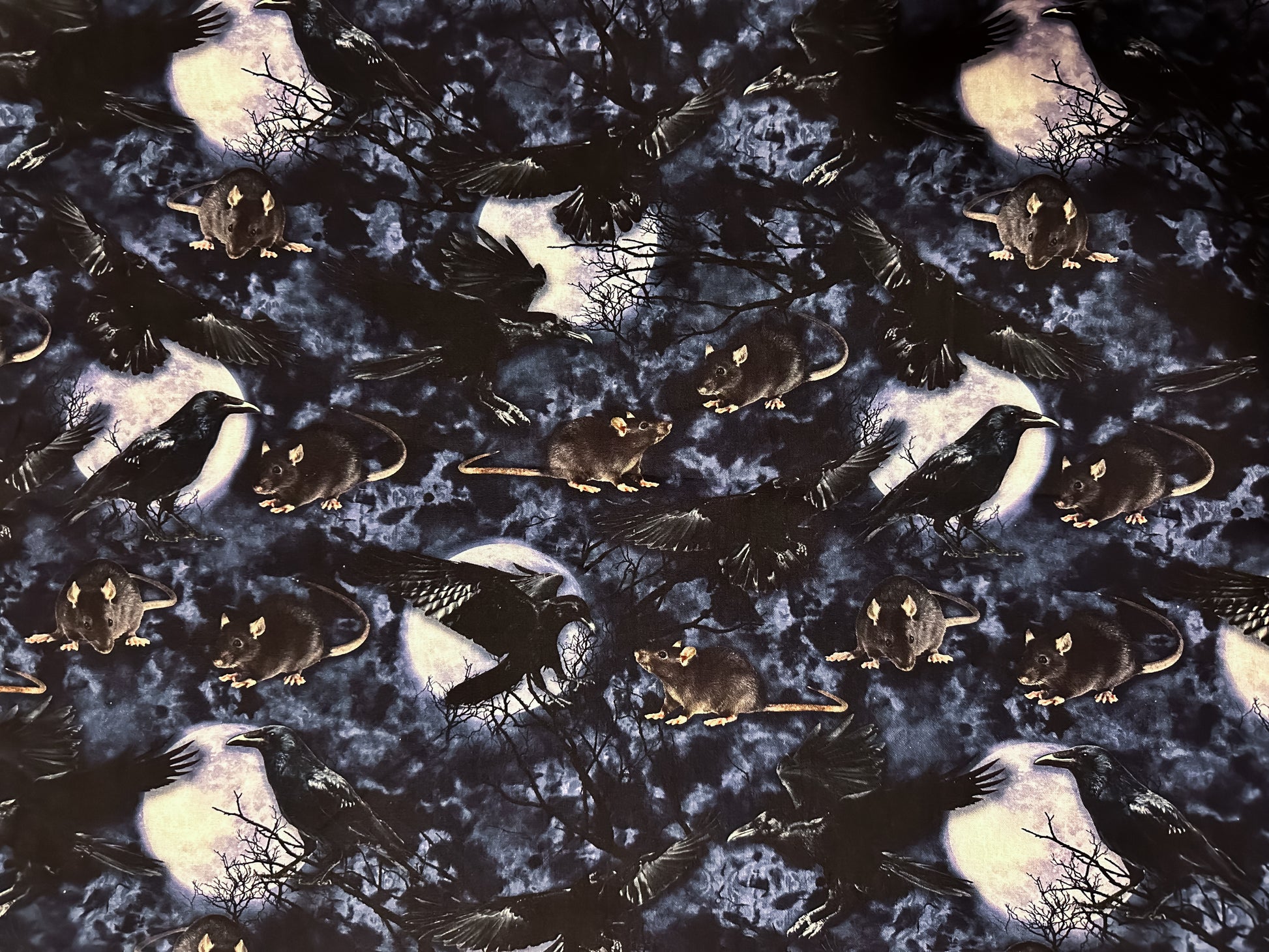 Photo of fabric - rats, crows, trees and the moon.