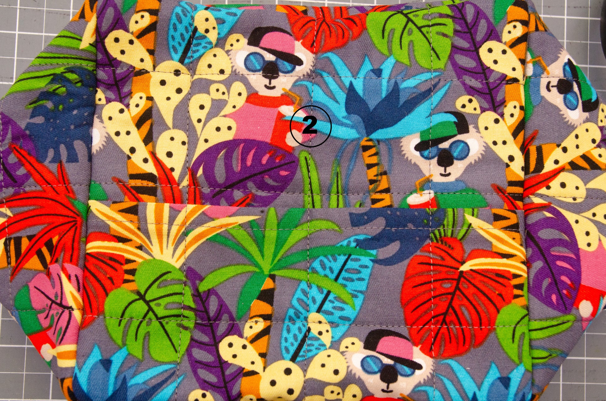 Flat lay cube hammock with koala fabric showing extra seam on bottom.