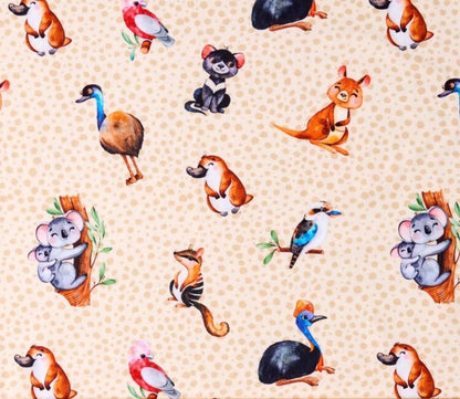 Photo of fabric print showing a pale brown background with cartoon characters depicting koalas, platapus, tasmanian devils, emus, kookaburras, numbats and galashs.
